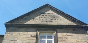Pitched stone roof with carved inscription